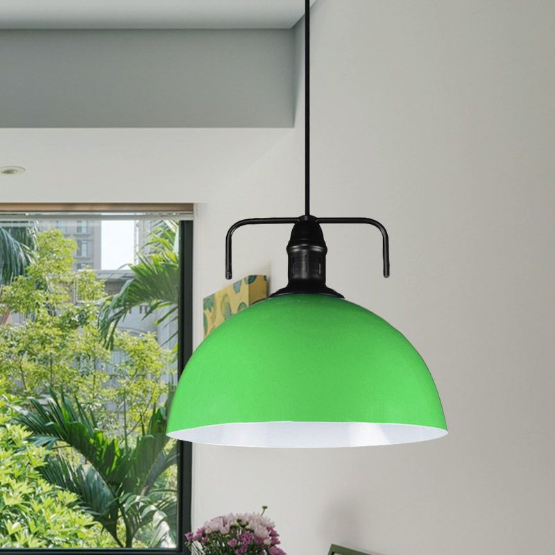Green dome pendant against garden-facing window