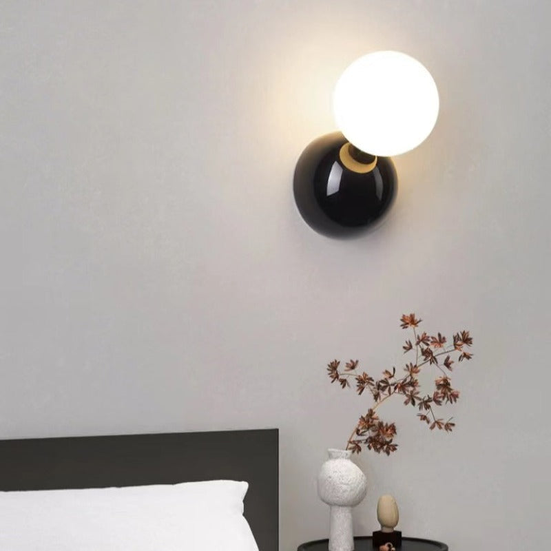 Valentina black-backplate globe light beside a bed