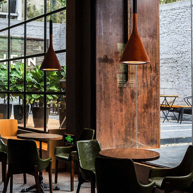 Two red cone pendants above restaurant table
