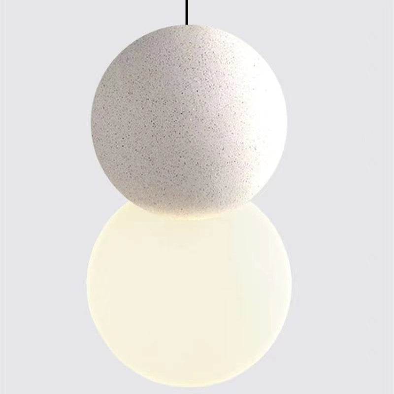 Close view of the speckled pale upper sphere and glowing white lower globe.
