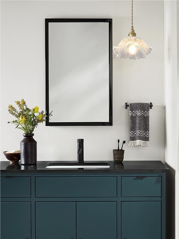 Compact clear lotus pendant shown beside a bathroom vanity