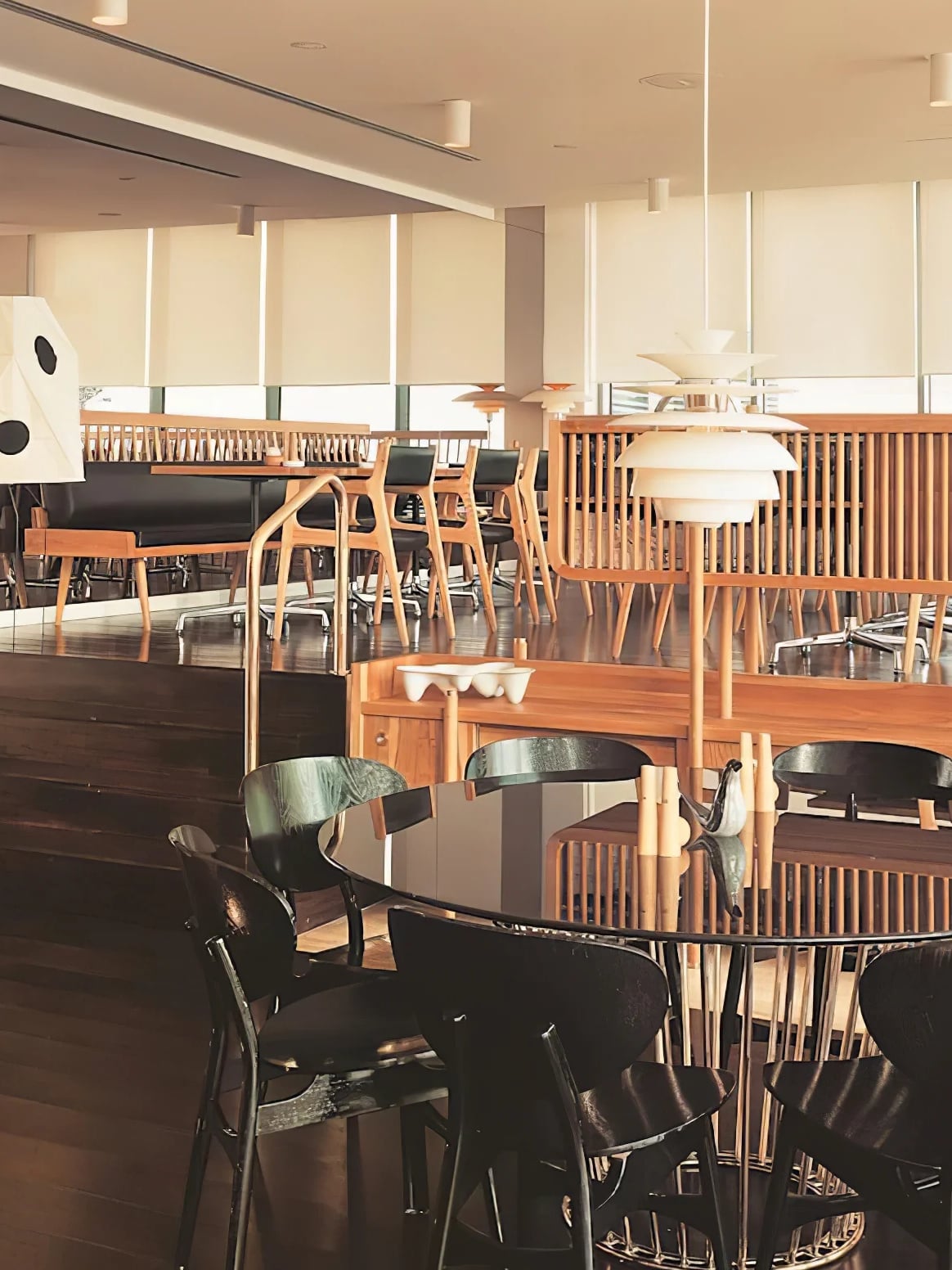 Multiple Snowball pendants pictured in a cafe interior