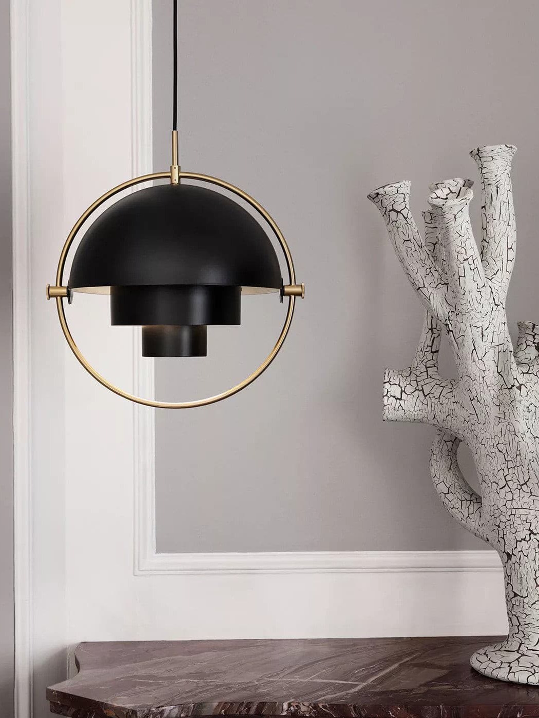 Black dome pendant in a copper-coloured circular frame