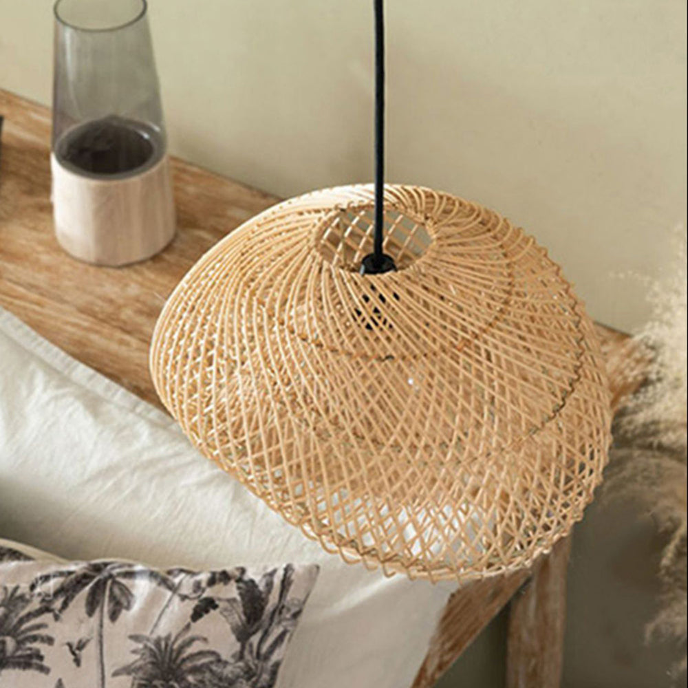 Top view of unlit Muto woven shade beside a wooden surface