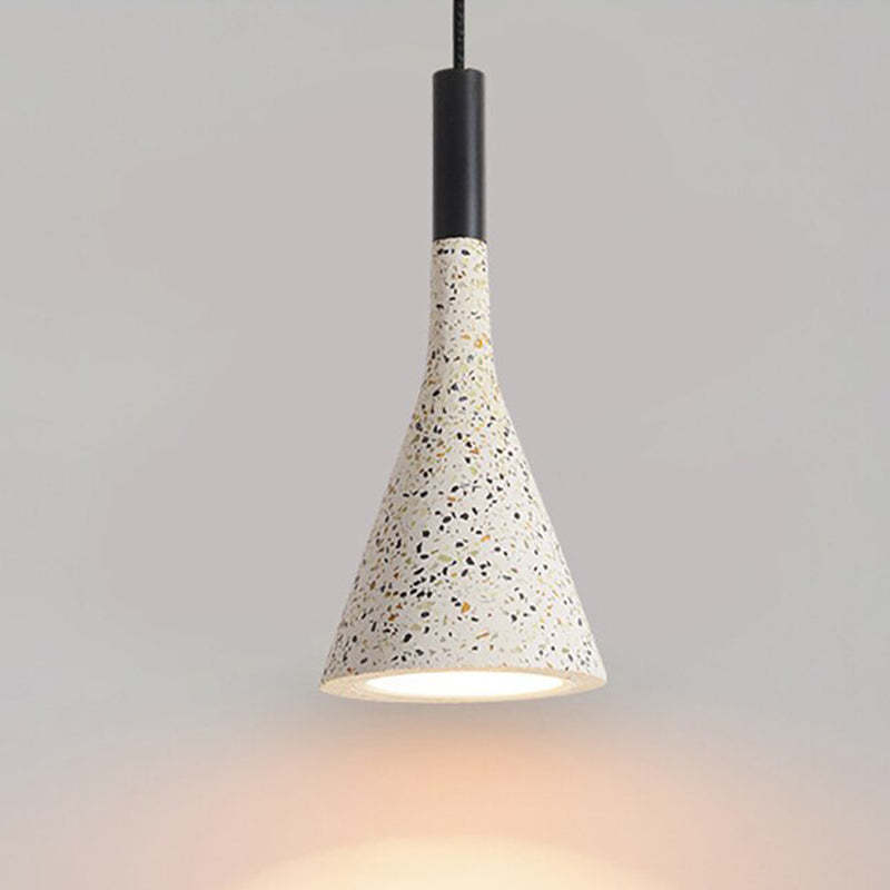 Tall tapered speckled cone with a black upper fitting and glowing lower opening