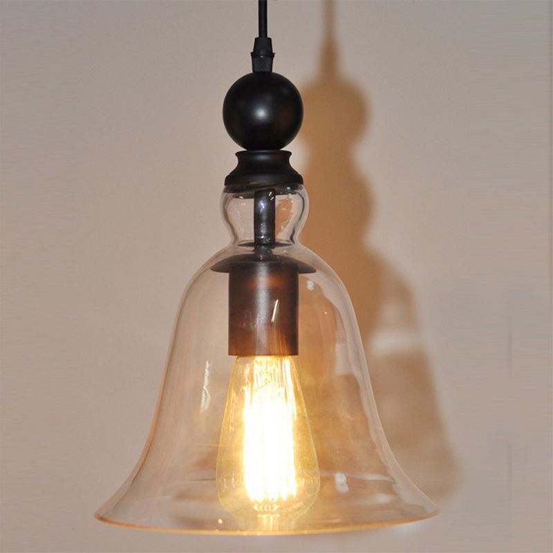 Close view of the Cooley clear bell shade with an illuminated filament-style bulb.