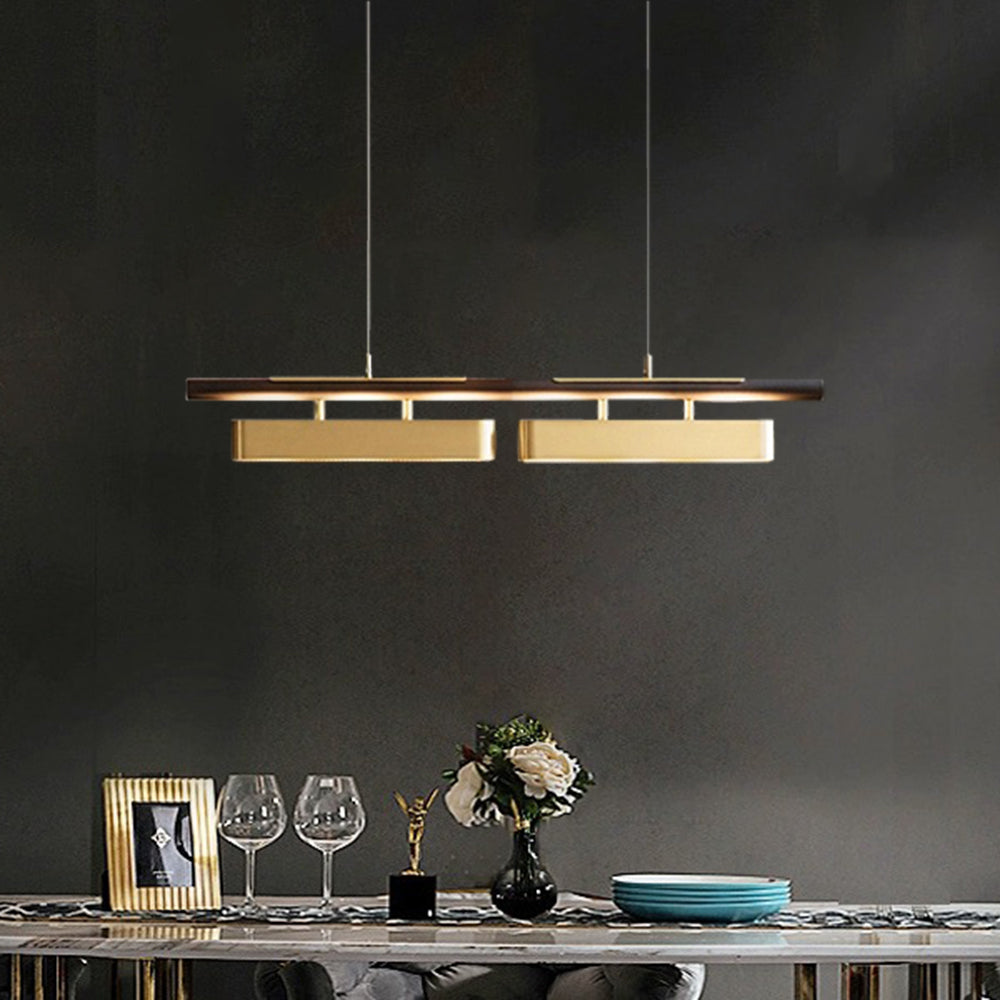 Two-shade black and brass-tone pendant above a dining table with glasses, flowers and stacked plates