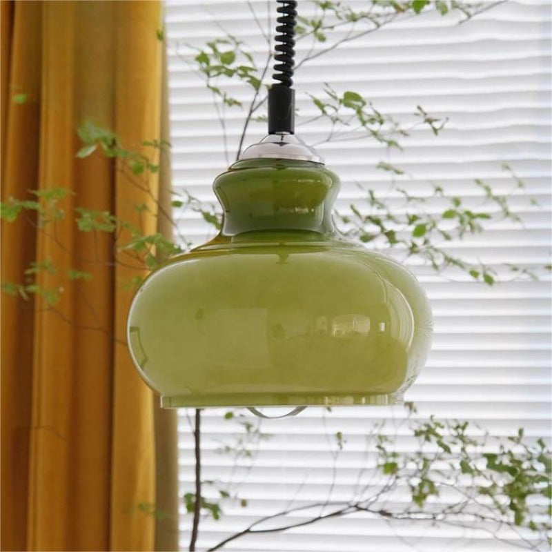 Green glass dome pendant near curtain and window