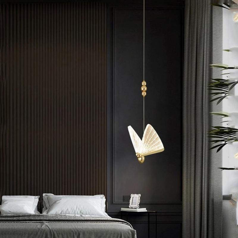 A pale-winged Kady butterfly pendant beside a bed