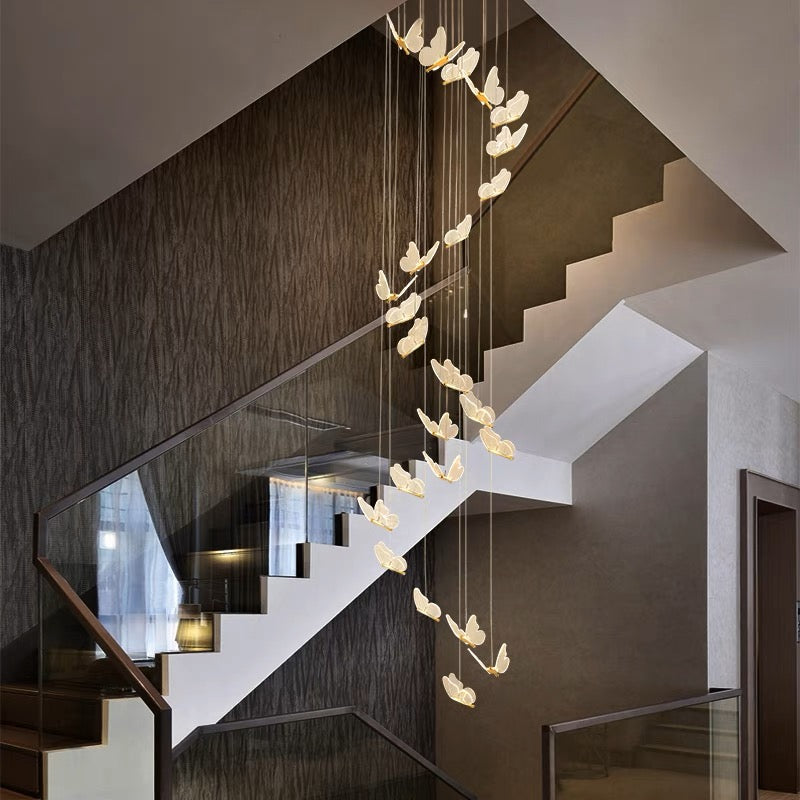 Long multi-butterfly light suspended near a staircase