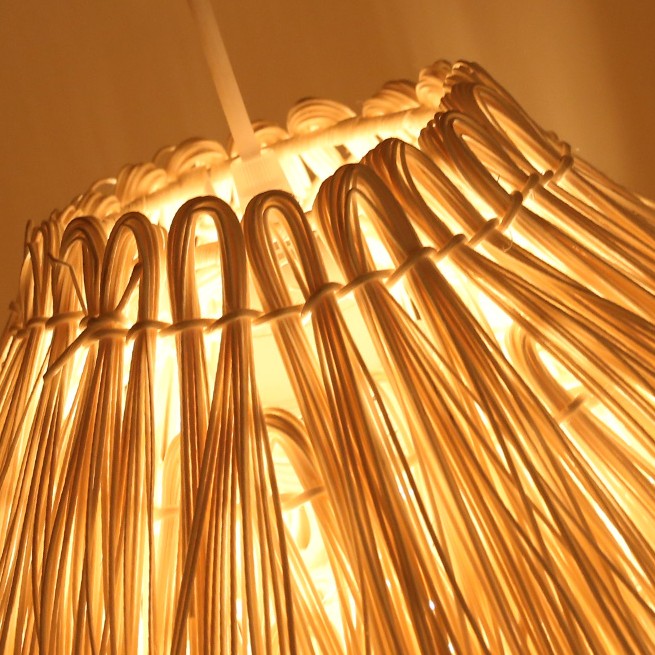 Close-up of the Muto shade showing woven loops and long overlapping rattan strips.