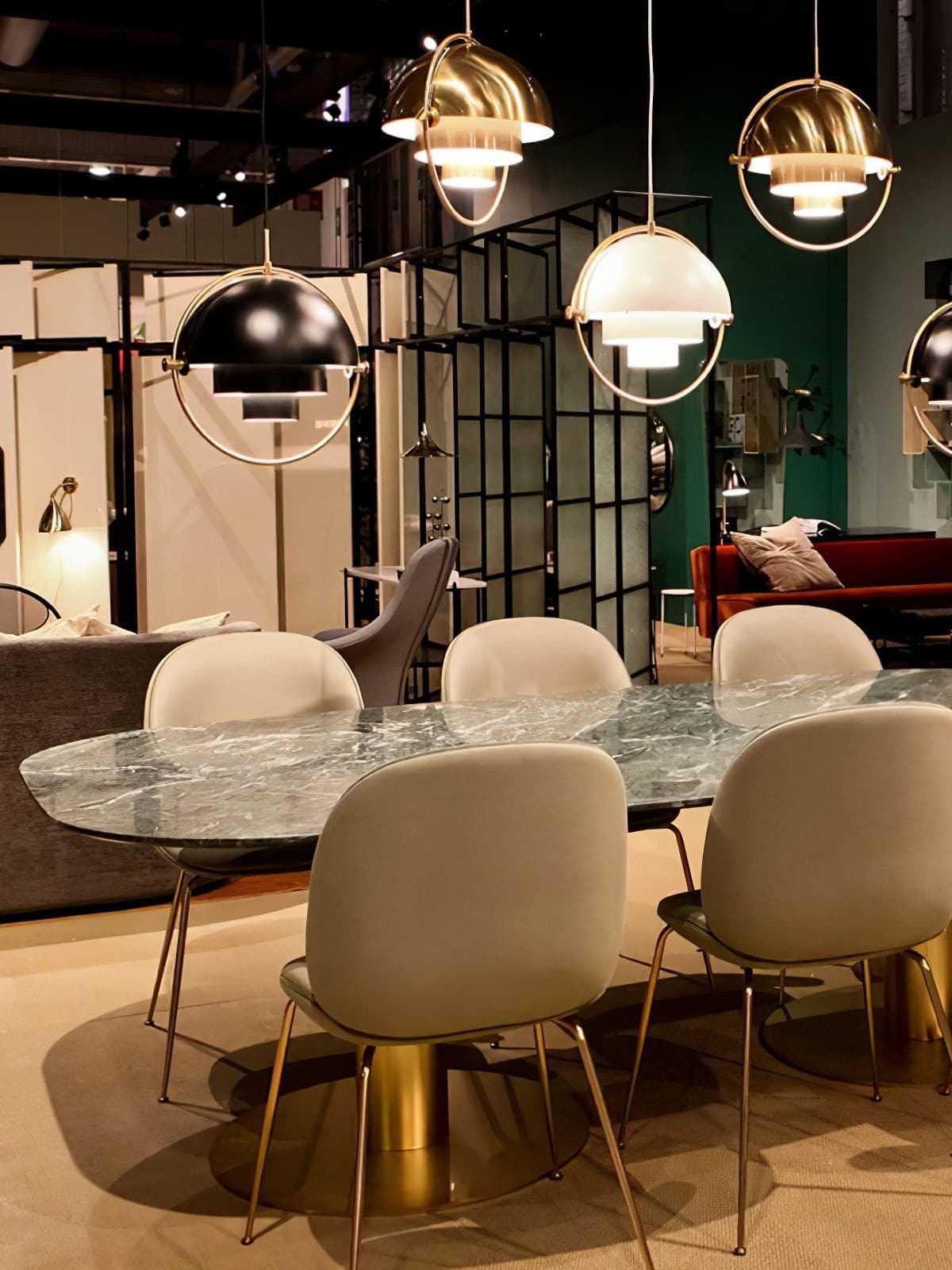 Mixed-finish rotating-shade pendants displayed over a table