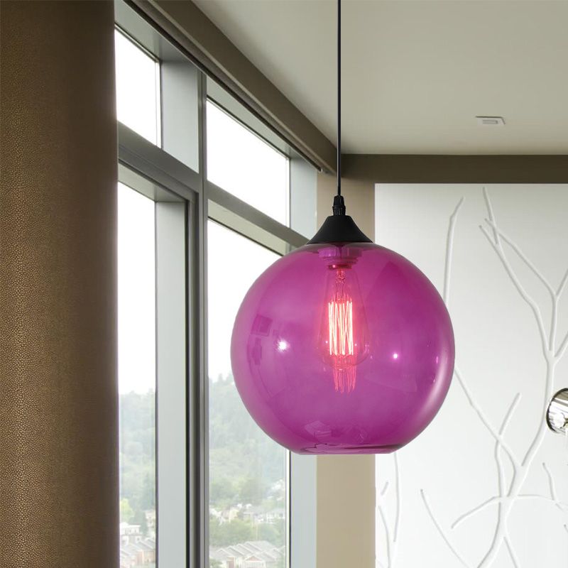 Purple glass globe pendant in a room