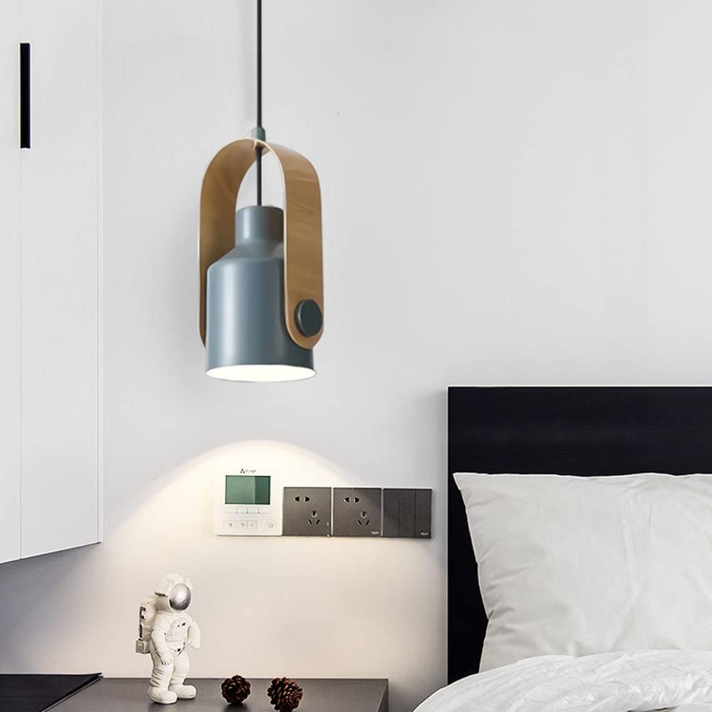 Silver-grey cylindrical spotlight in wood-look bracket by bed