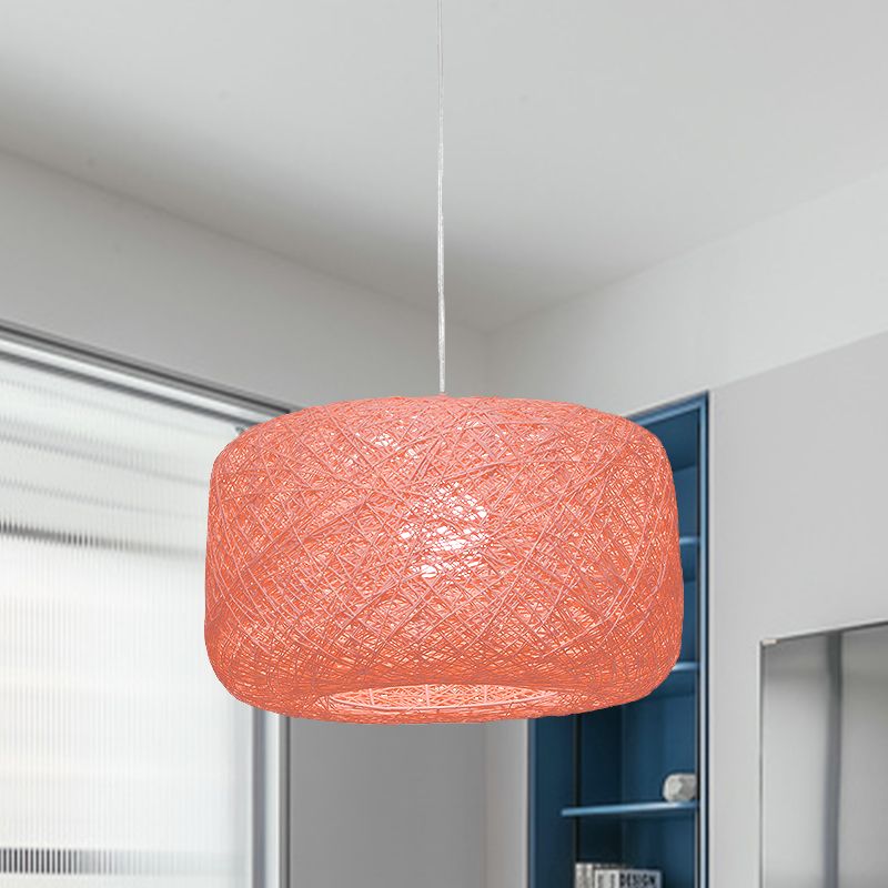 Pink woven rattan cylinder pendant in light room