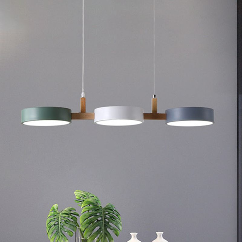 Front view of the aligned green white and gray lampshades