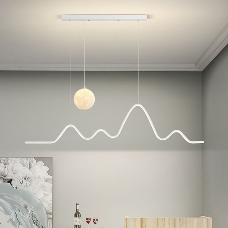 White glowing wave light and globe above a table
