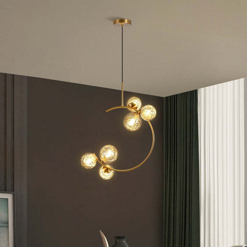 Clear six-globe crescent pendant with a black cord beside grey curtains