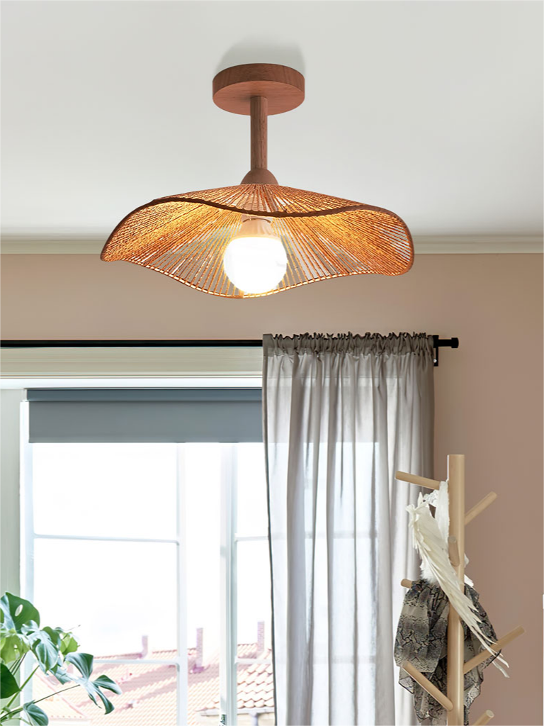 Hazel curved shade and visible bulb near a window with grey curtains.