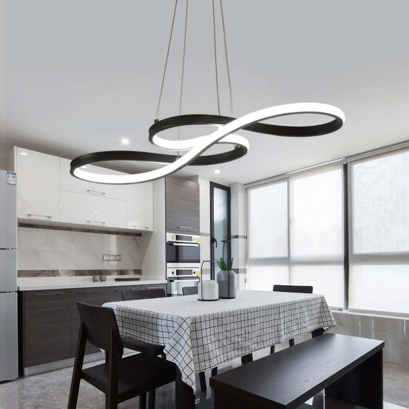 Black luminous-loop pendant above a kitchen table