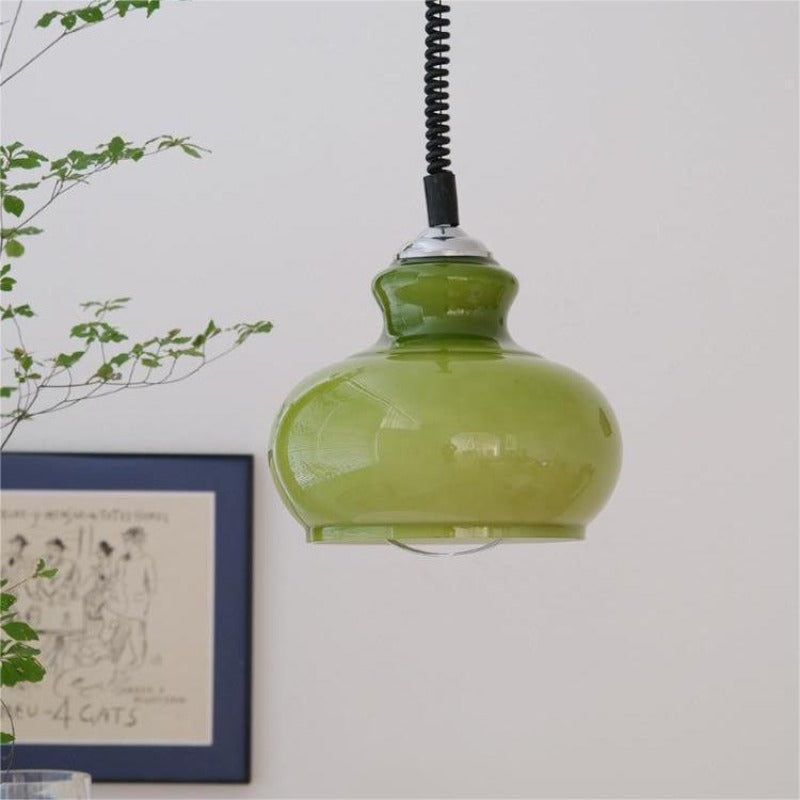 Green rounded glass pendant near framed wall art