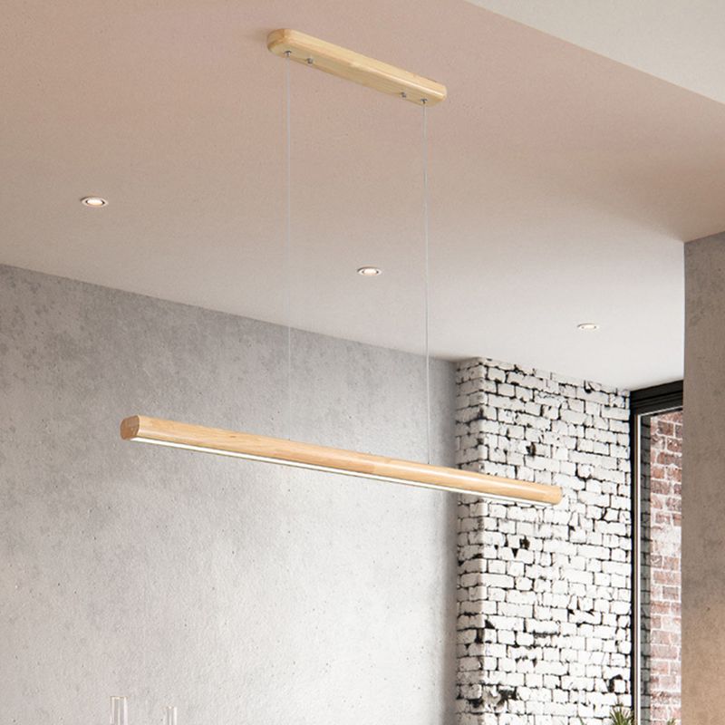 Wooden linear pendant in concrete and brick dining room