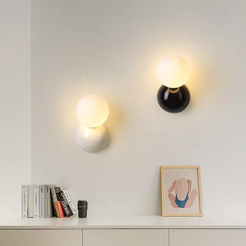 Black and white Valentina globe wall lights pictured above a shelf