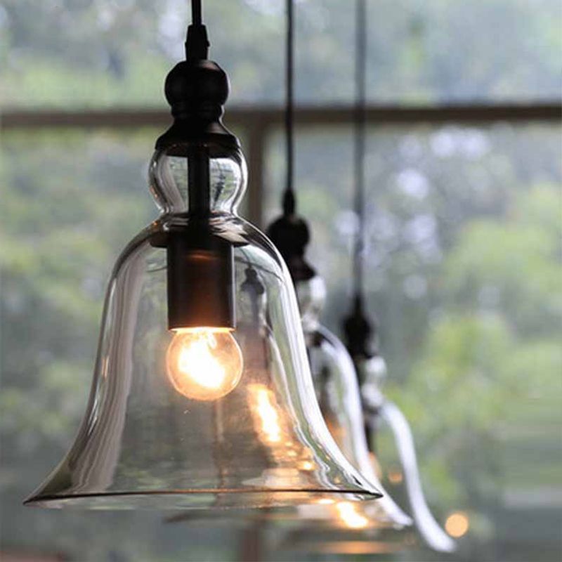 Cooley clear glass bell pendants hanging beside a window.