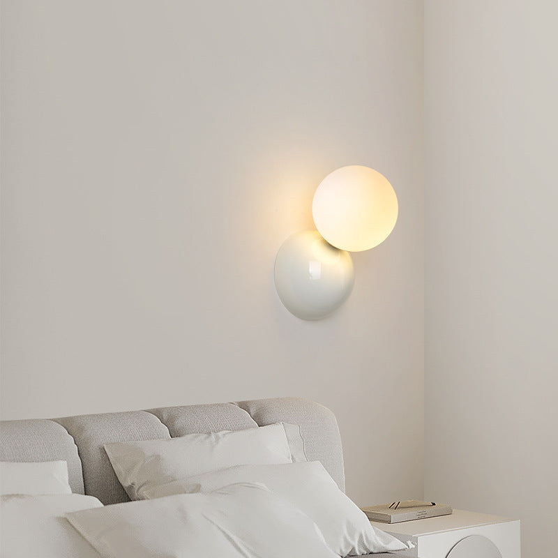 Valentina white-backplate globe light above a bedside table