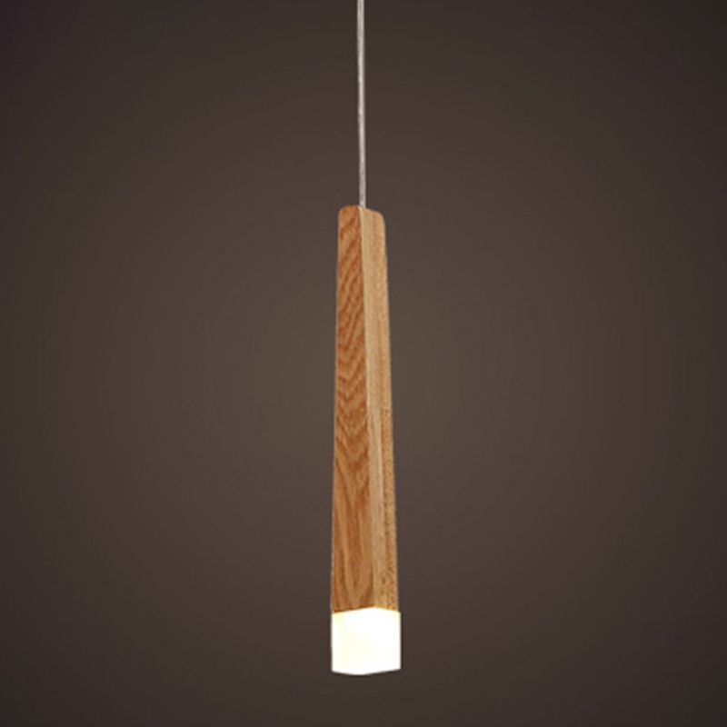 Illuminated Ozawa wood column pendant with a bright white tip against a dark brown background.
