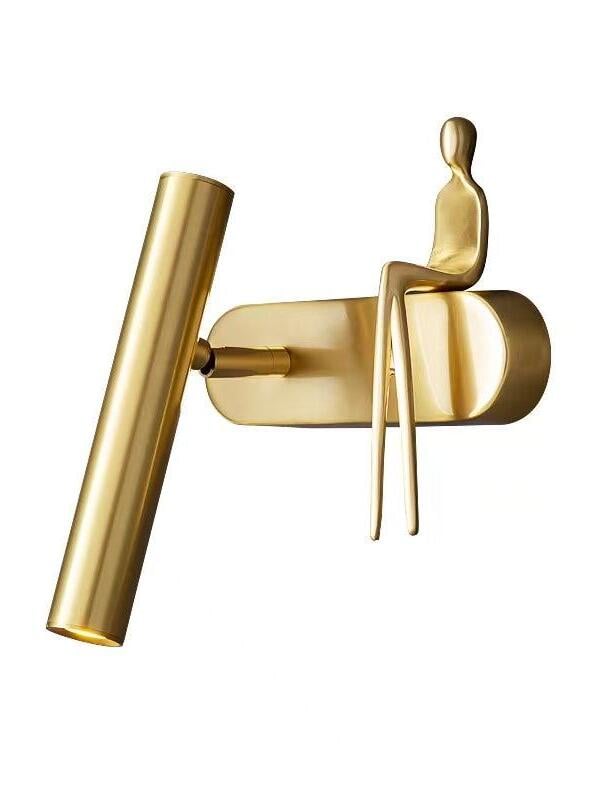 Single brass-coloured wall light isolated on white with tube on the left and seated figure on the right