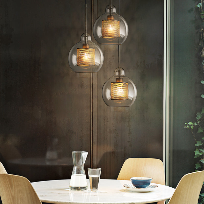Three globe pendants above round dining table