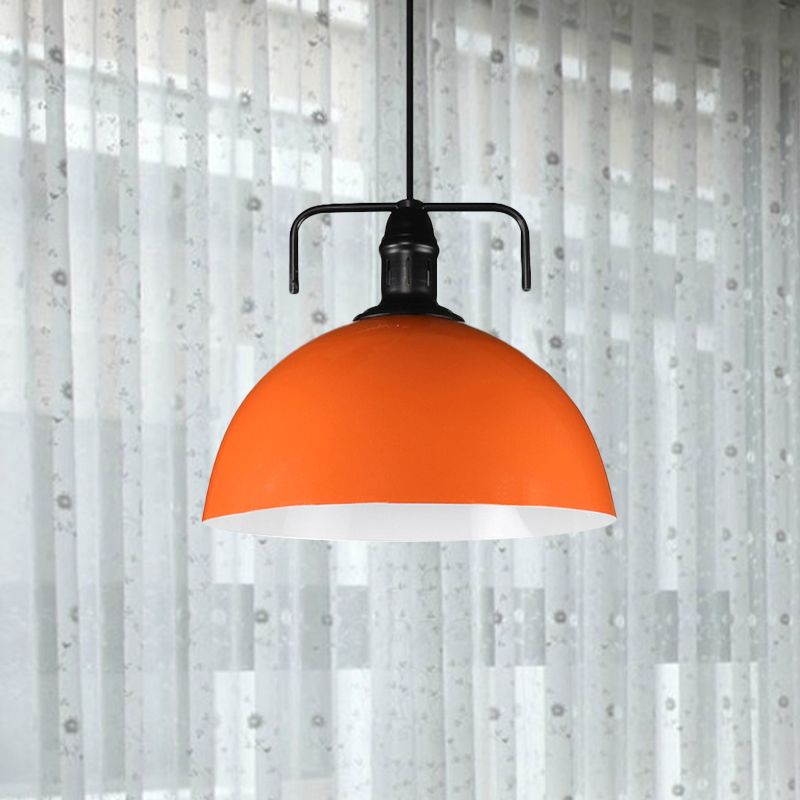 Orange dome pendant before sheer curtains