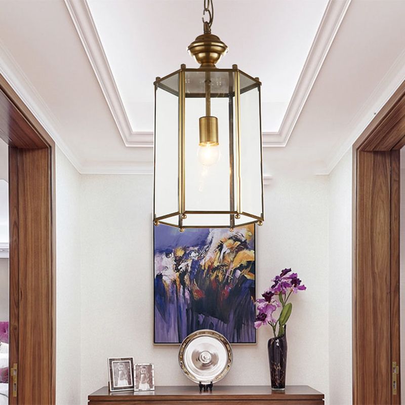 Sanna lantern pendant illuminated in a hallway above a console.