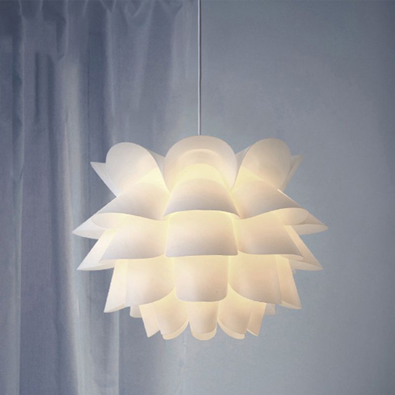 Cairns flower pendant glowing beside pale curtains