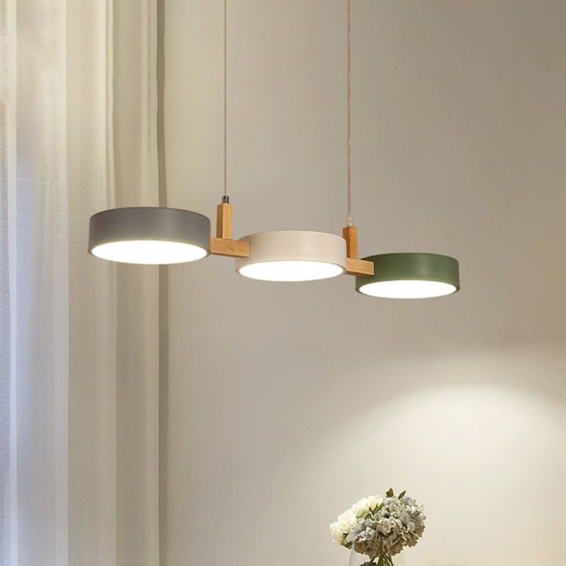 Glowing gray white and green pendant heads in a dining interior