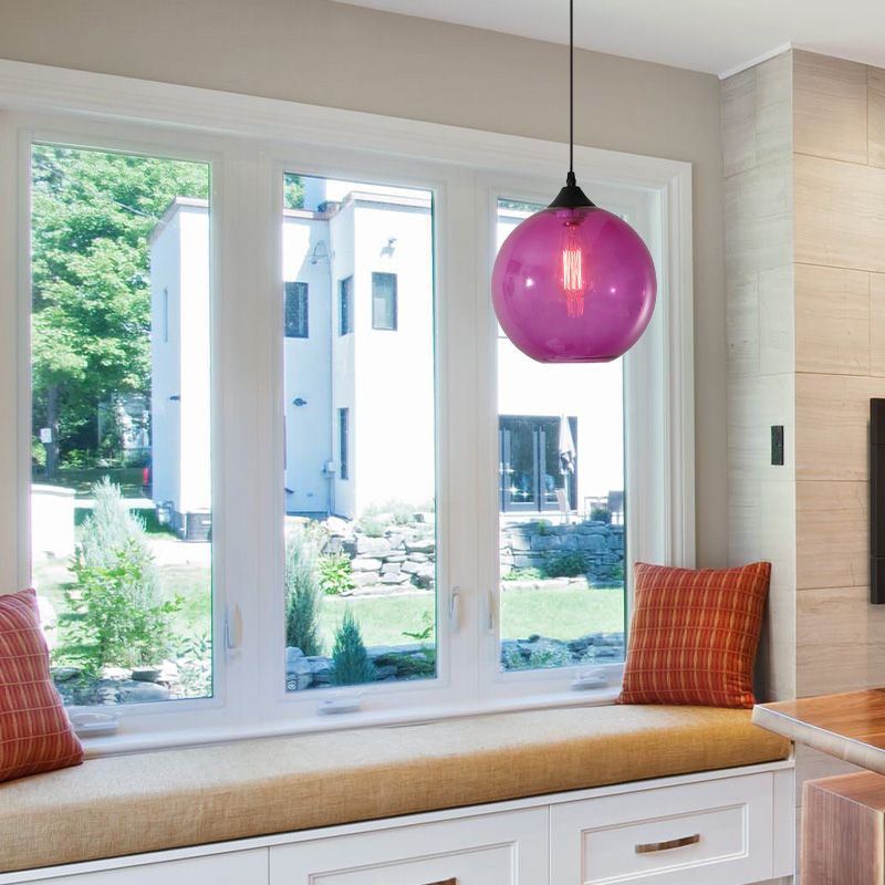 Purple glass globe pendant near a window seat