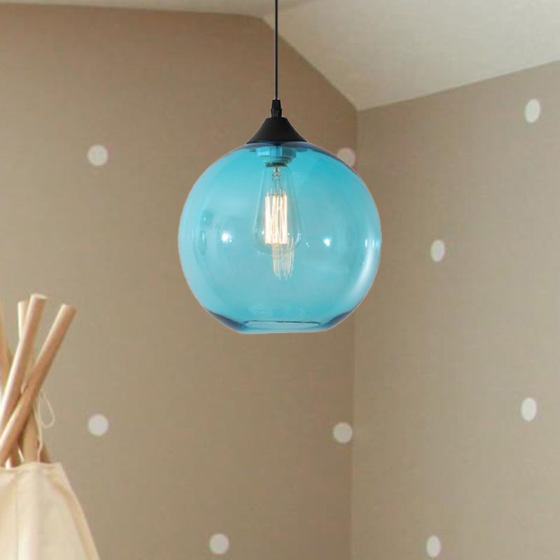 Sky Blue glass globe pendant against tan wall