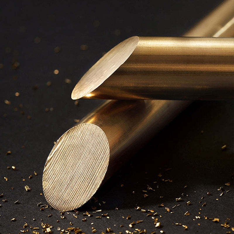 Material illustration of cut brass-coloured rods beside fine metal shavings
