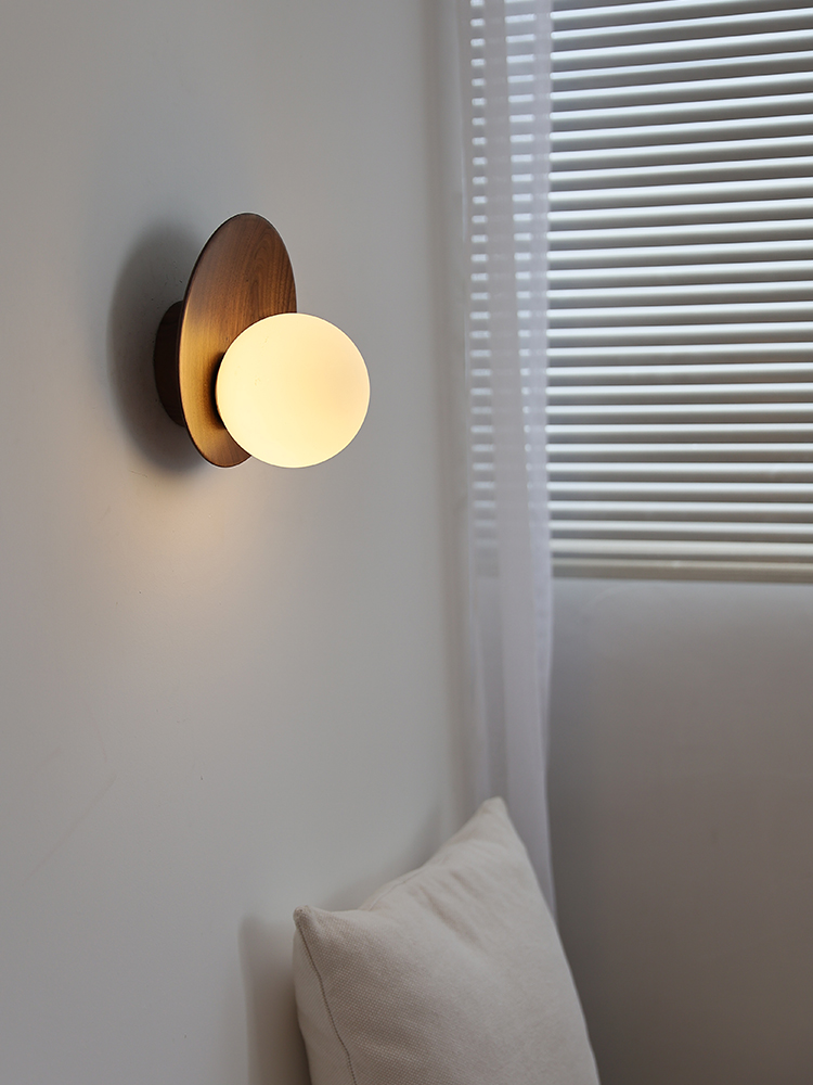 Lunetta wall light beside a window and upholstered furniture