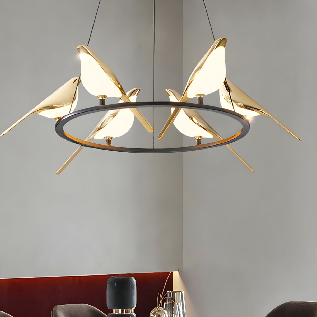 Bird ring pendant above dining table and red upholstery