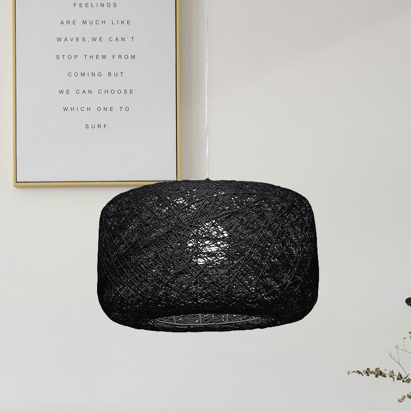 Black woven rattan cylinder pendant in pale room