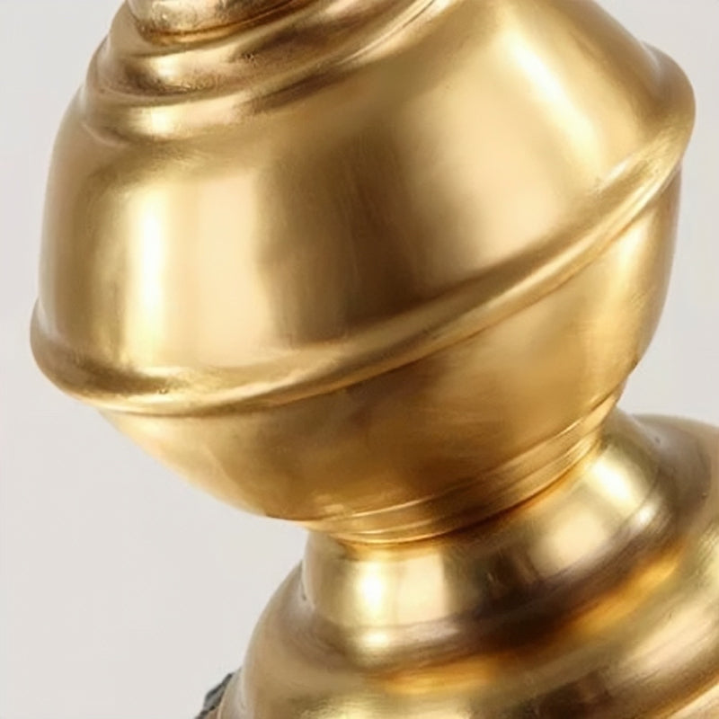 Close view of the rounded brass-tone metal ornament above the Sanna lantern.