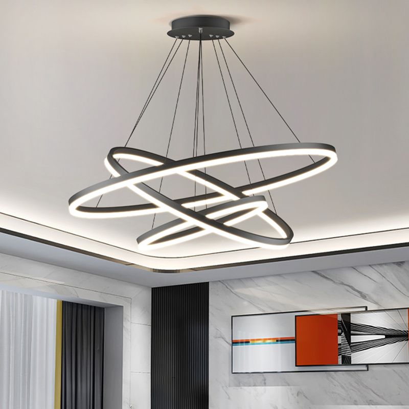 Low-angle view of lit intersecting Arisha rings in a living room