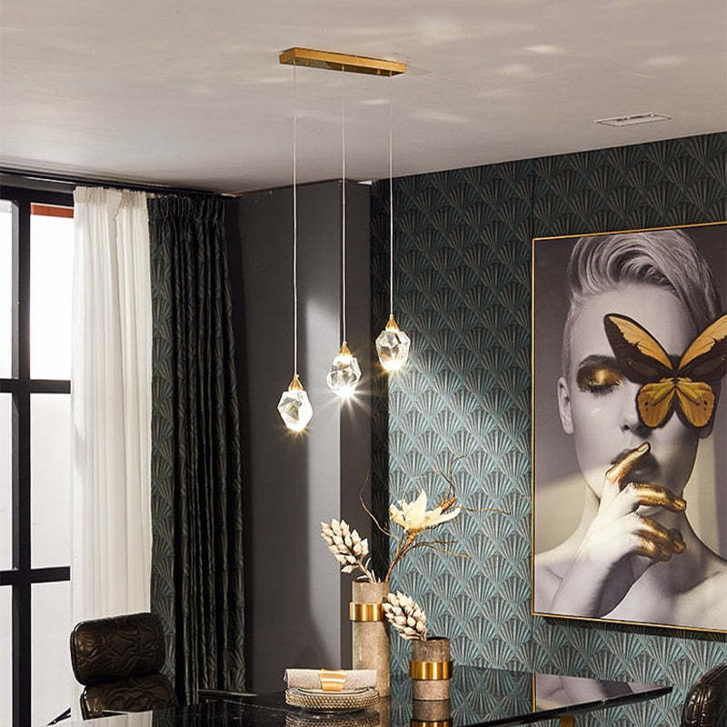 Kristy 3 Heads pendant on a gold rectangular canopy in a dining room
