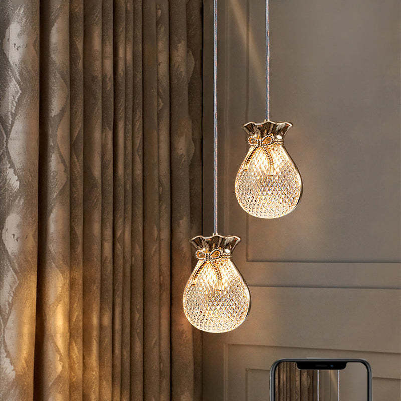 Two pouch-shaped Hailie lights at staggered heights beside curtains.