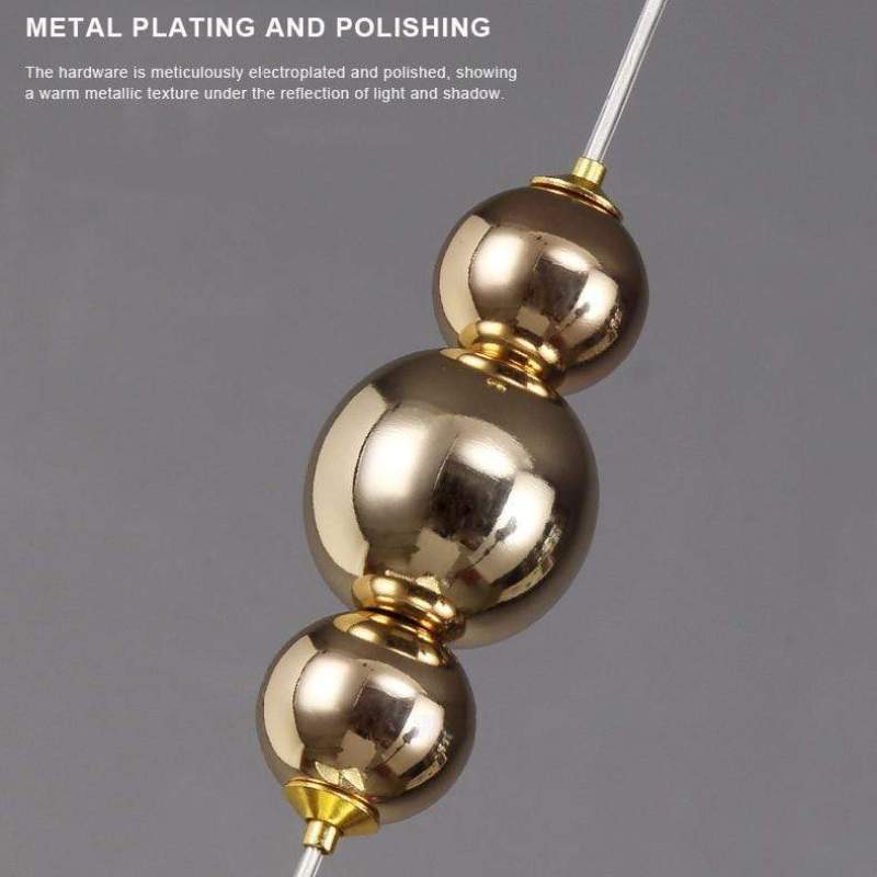Three polished gold spheres along the Kady pendant suspension