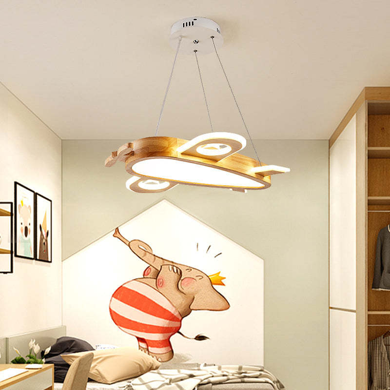 Wood-colour airplane pendant above a bed with a red-striped elephant mural and wood-edged wardrobe
