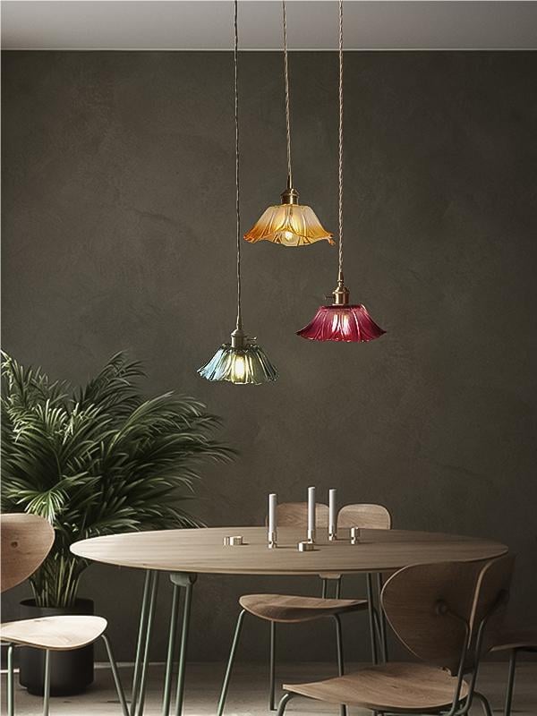 Yellow, green and purple compact lotus pendants above dining seating