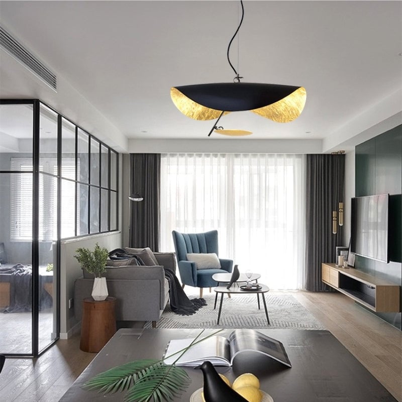 Renée sculptural pendant hanging in a living room with a sofa